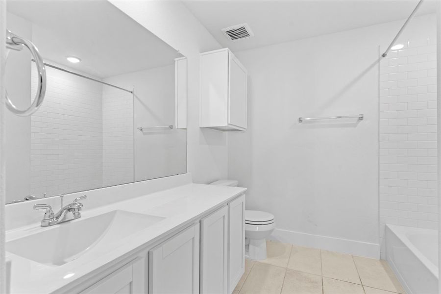 The upstairs guest bathroom offers a clean, spacious layout with a classic tub and shower combo—perfect for family or visitors. White cabinetry and open shelving provide both function and style. The upstairs guest bathroom offers a clean, spacious layout with a classic tub and shower combo—perfect for family or visitors. White cabinetry and open shelving provide both function and style.