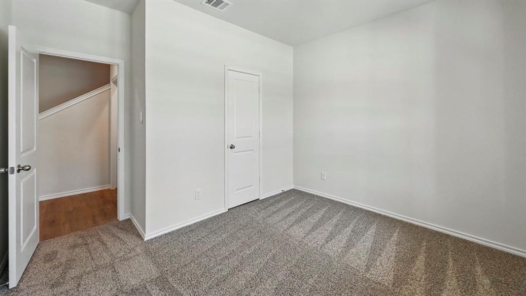 Unfurnished bedroom featuring carpet flooring and baseboards