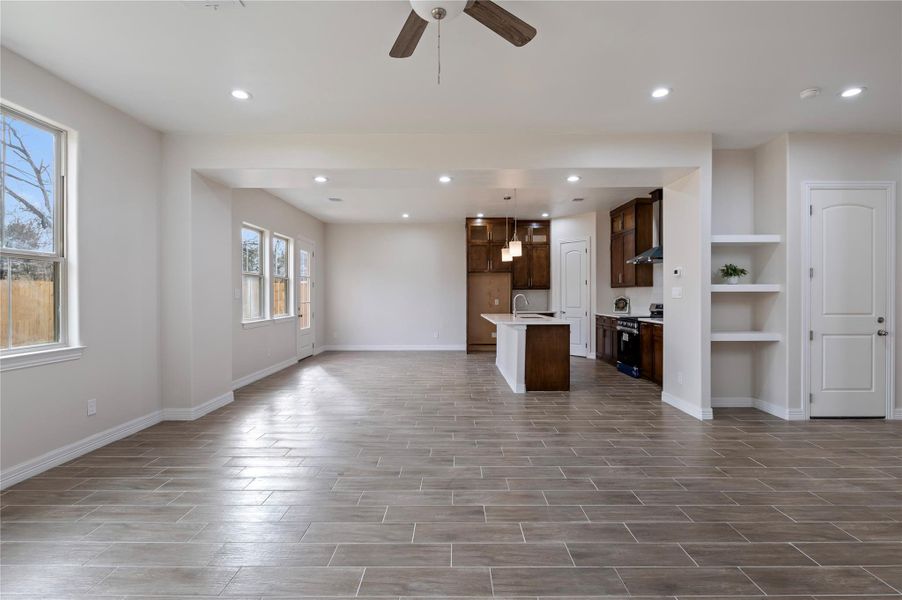 Living room open to dining and kitchen.