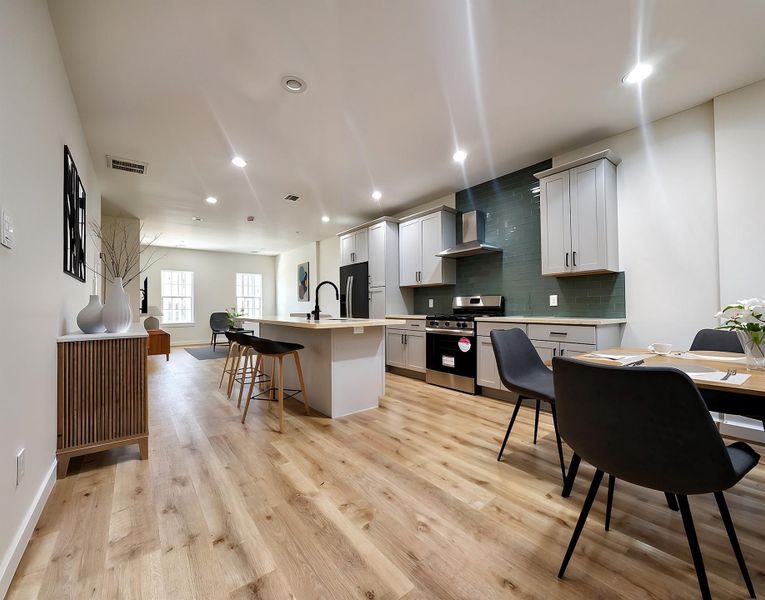 Open concept kitchen, living and dining room. Quartz countertops and stainless steel appliances. Virtually staged.