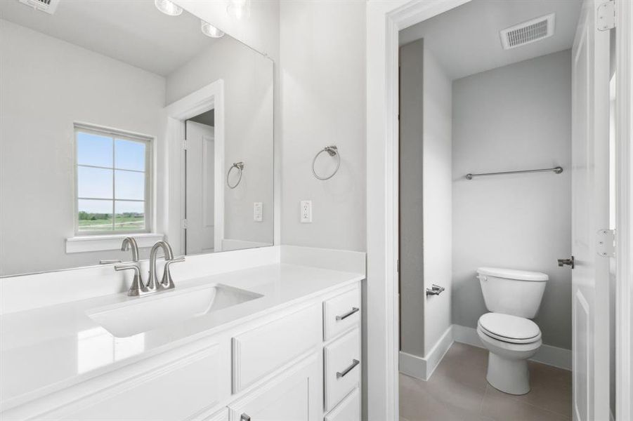 Bathroom featuring vanity and tile patterned floors Bathroom featuring vanity and tile patterned floors