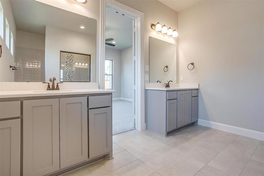 Bathroom featuring tile patterned flooring and double vanity