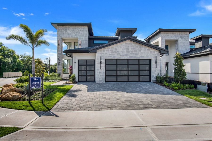 Front exterior of a new home in Hampton Green at Providence, Davenport, FL, highlighting curb appeal (Image 13).