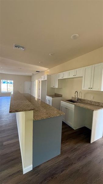 I'm a fan of the kitchen in this house. There are plenty of cabinets for all of our stuff, and there will be newer appliances.