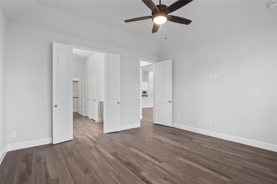 View from Primary bedroom into the double door entry to Primary Bathroom. View from Primary bedroom into the double door entry to Primary Bathroom.