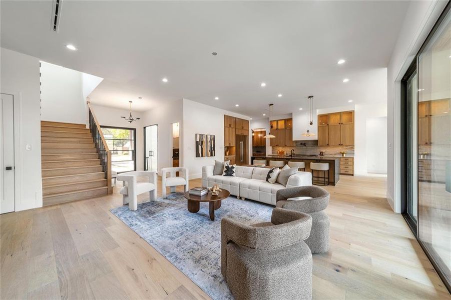 Living area featuring light wood-style floors and a chandelier
