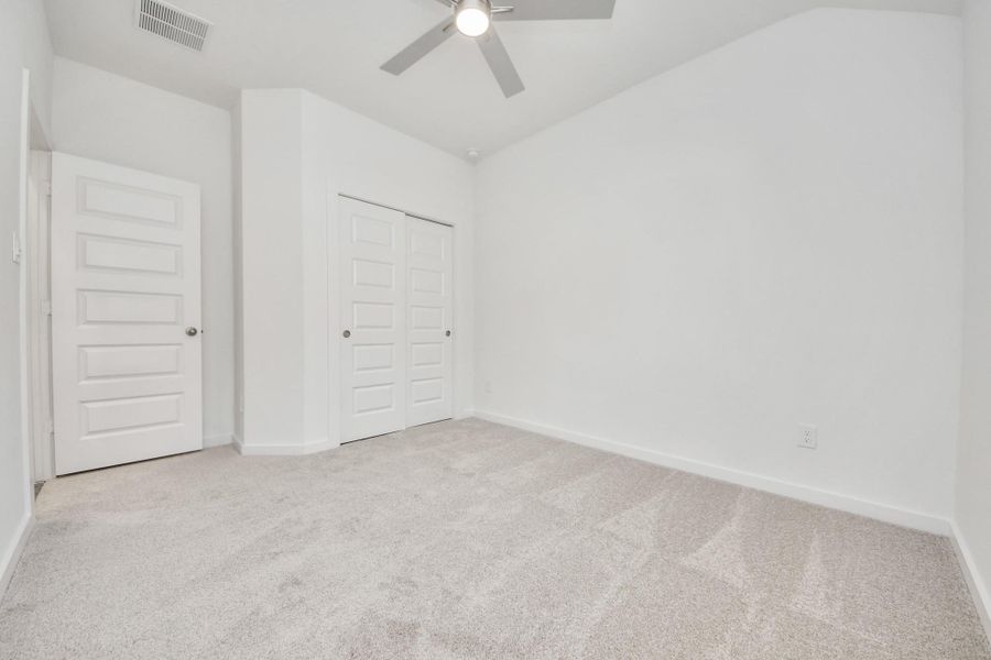 Generously sized secondary bedrooms featuring spacious closets, soft and inviting carpeting underfoot, large windows allowing plenty of natural light, and the added touch of privacy blinds for your personal retreat.