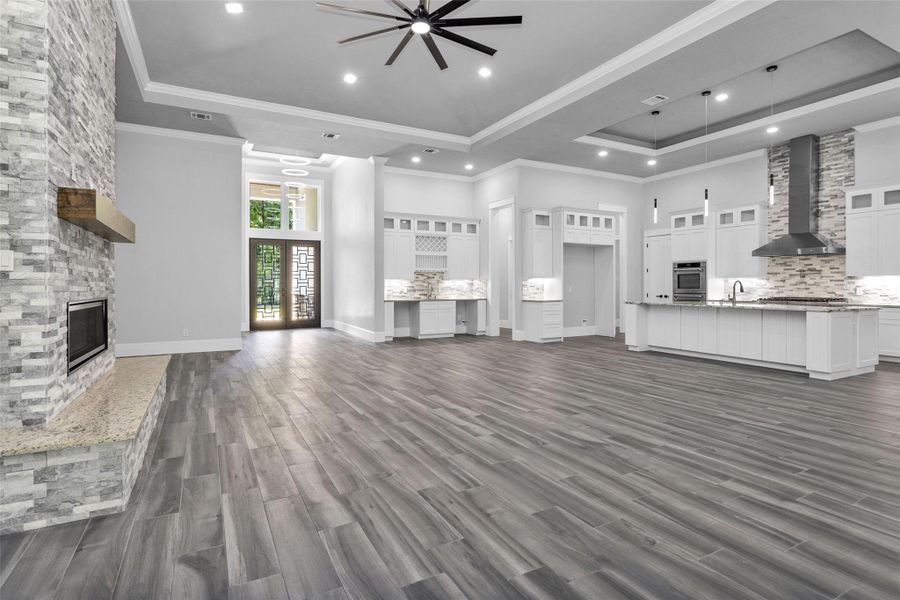 Open-concept design features a wet bar with space for both a wine fridge & beverage fridge, along with the space for a 60" built-in refrigerator.