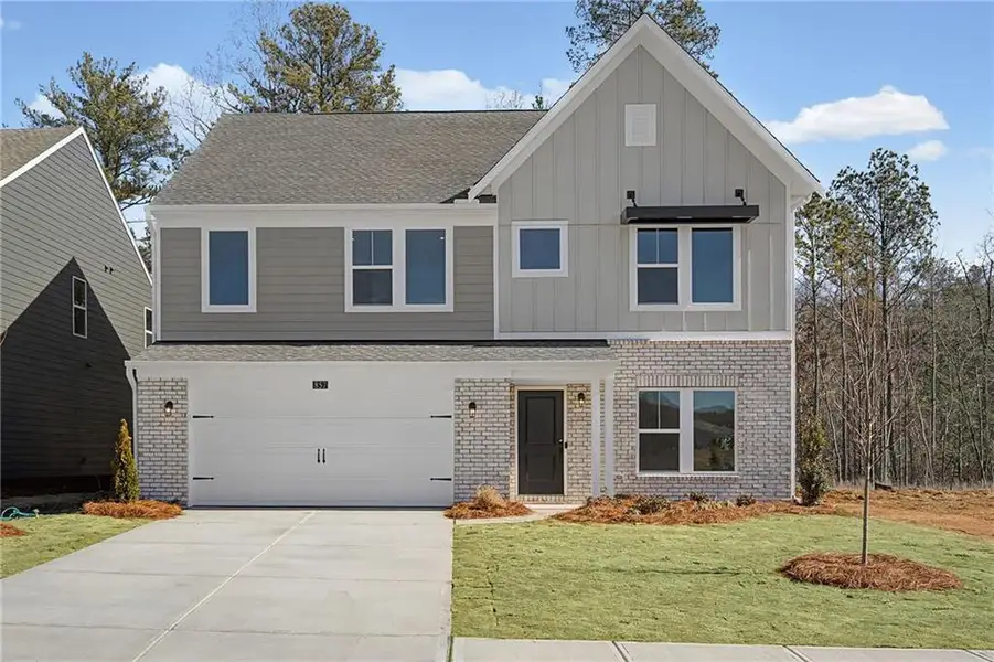 Front exterior of a new home in Twin Lakes, Hoschton, GA, highlighting curb appeal (Image 2). Front exterior of a new home in Twin Lakes, Hoschton, GA, highlighting curb appeal (Image 2).