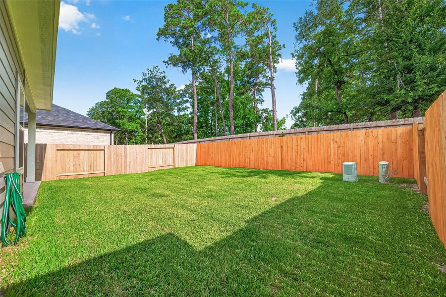 Exterior details and patio area of a home in Mill Creek Trails, Magnolia (Image 30).