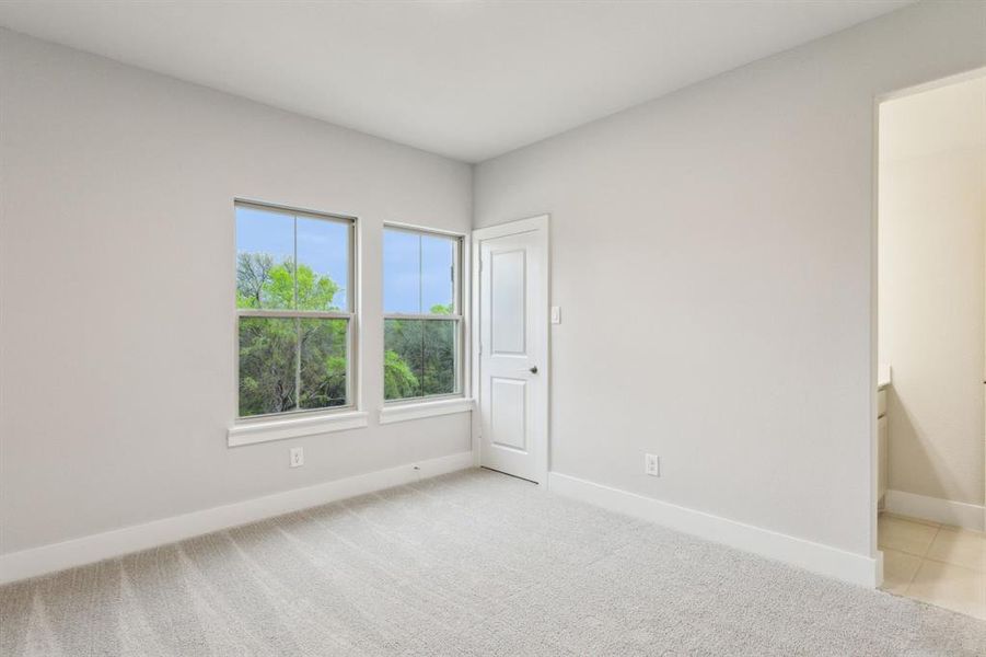 Empty room with light colored carpet