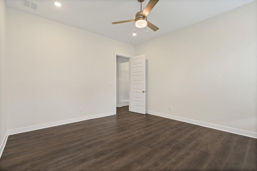 Spacious room featuring wood-finish flooring, recessed lighting, and a ceiling fan with integrated light Spacious room featuring wood-finish flooring, recessed lighting, and a ceiling fan with integrated light
