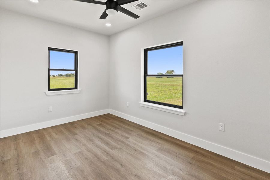 Additional secondary bedroom located near the full guest bathroom, offering flexibility for guests, hobbies, or everyday living. Includes a closet and ample natural light.