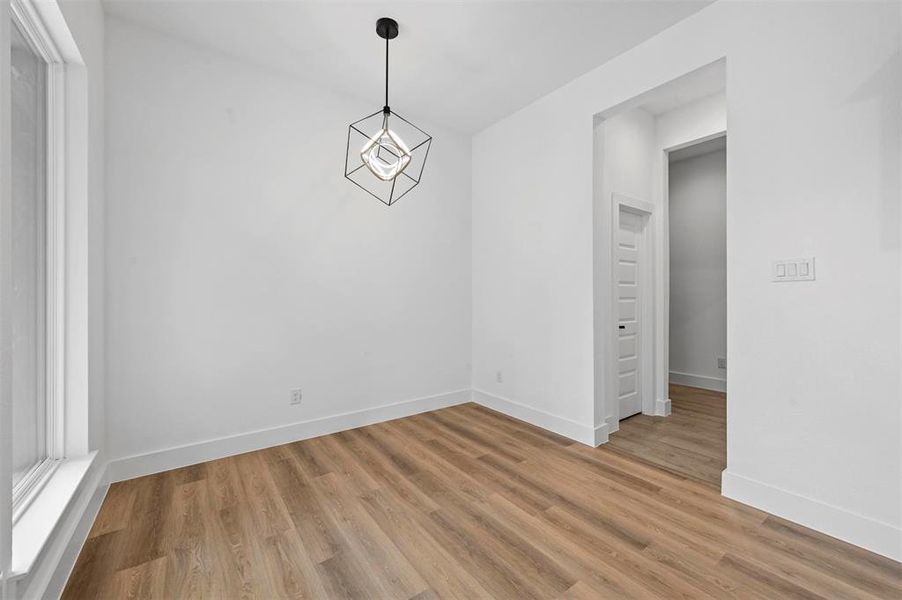 Unfurnished dining area featuring wood-type flooring