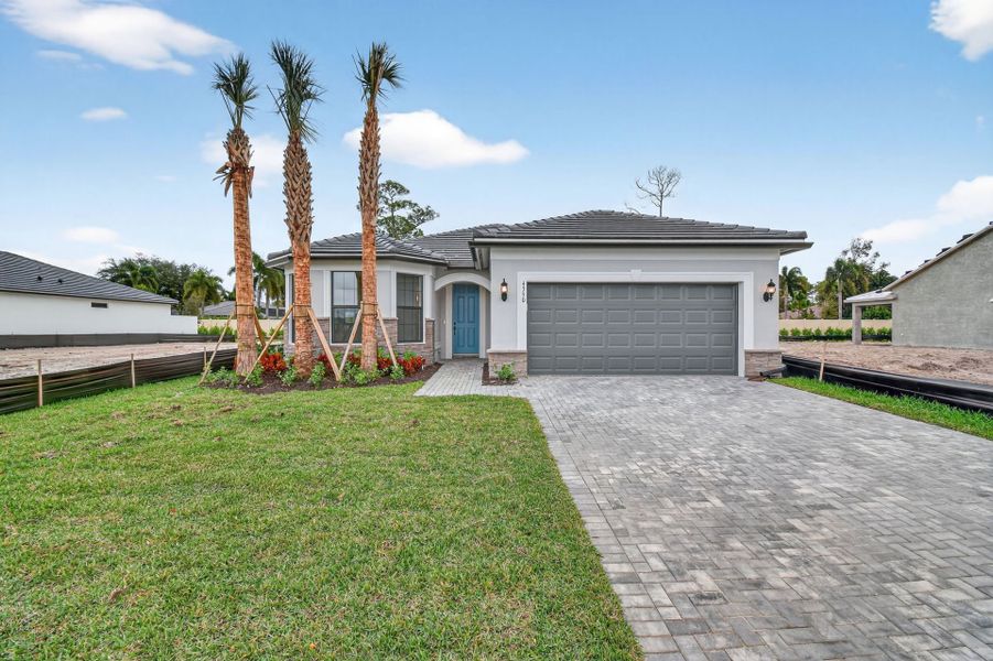 Front exterior of a new home in Hendrix Reserve, Lake Worth, FL, highlighting curb appeal (Image 23).