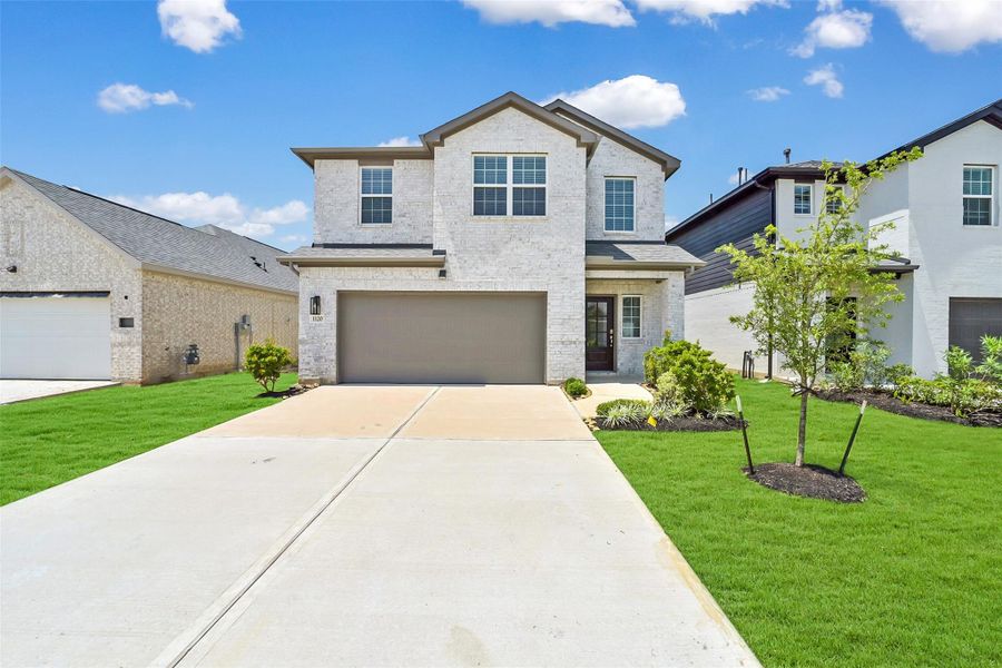 Front exterior of a new home in Saint Tropez, Houston, TX, highlighting curb appeal (Image 1). Front exterior of a new home in Saint Tropez, Houston, TX, highlighting curb appeal (Image 1).