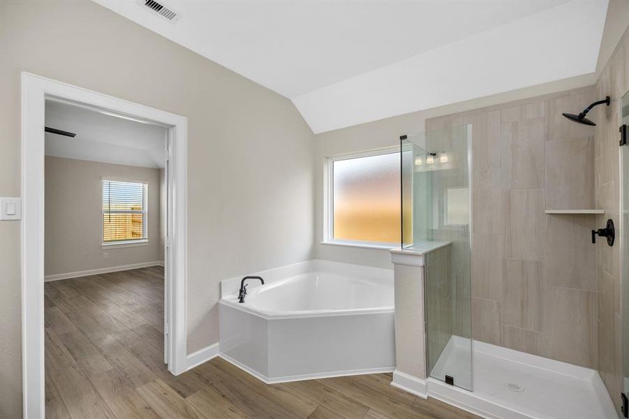 You will love relaxing at the end of the day with your spa like corner garden tub.