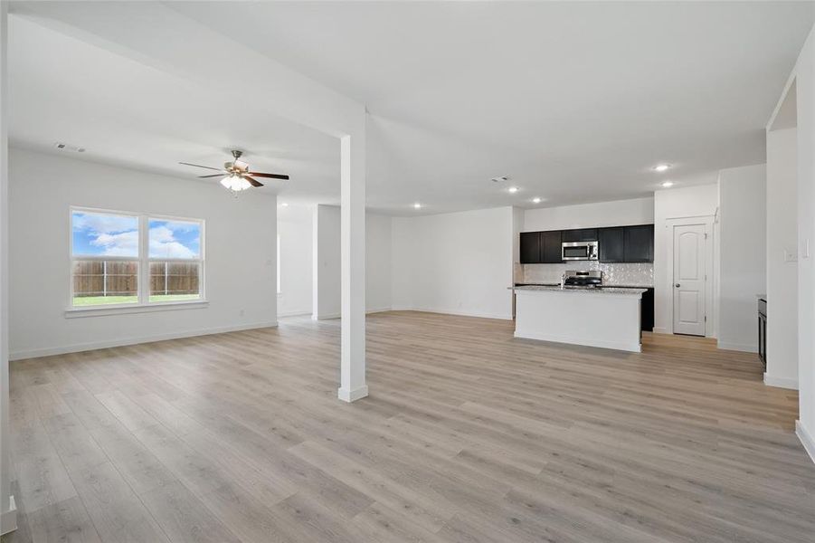 Unfurnished living room with visible vents, baseboards, ceiling fan, recessed lighting, and light wood-style flooring Unfurnished living room with visible vents, baseboards, ceiling fan, recessed lighting, and light wood-style flooring