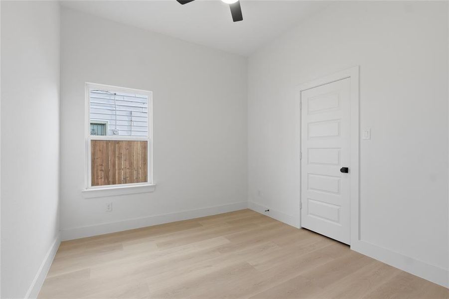 Unfurnished room featuring light wood-style flooring and ceiling fan Unfurnished room featuring light wood-style flooring and ceiling fan