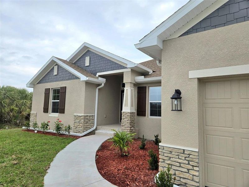 Front exterior of a new home in South Gulf Cove, Port Charlotte, FL, highlighting curb appeal (Image 11).