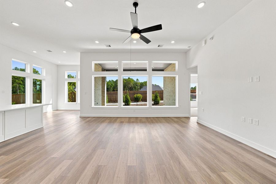 Expansive family room filled with natural light and overlooking the covered outdoor living area—ideal for relaxing or entertaining.