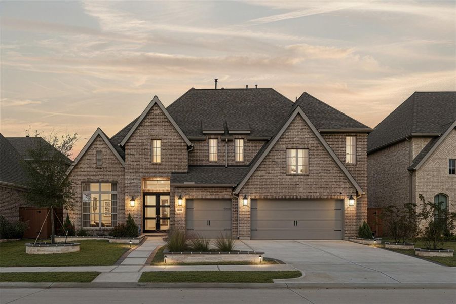 Elegant two-story brick home with a spacious three-car garage. Features modern lighting, well-maintained landscaping, and a welcoming entrance. Perfect for families seeking a stylish and functional living space. Elegant two-story brick home with a spacious three-car garage. Features modern lighting, well-maintained landscaping, and a welcoming entrance. Perfect for families seeking a stylish and functional living space.