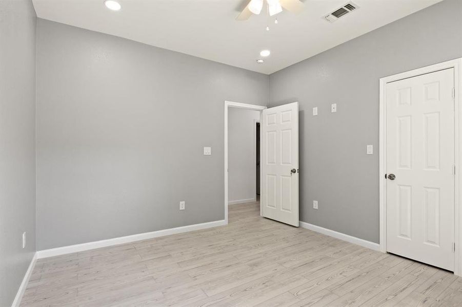 Unfurnished bedroom featuring light wood-style floors, a ceiling fan, and recessed lighting