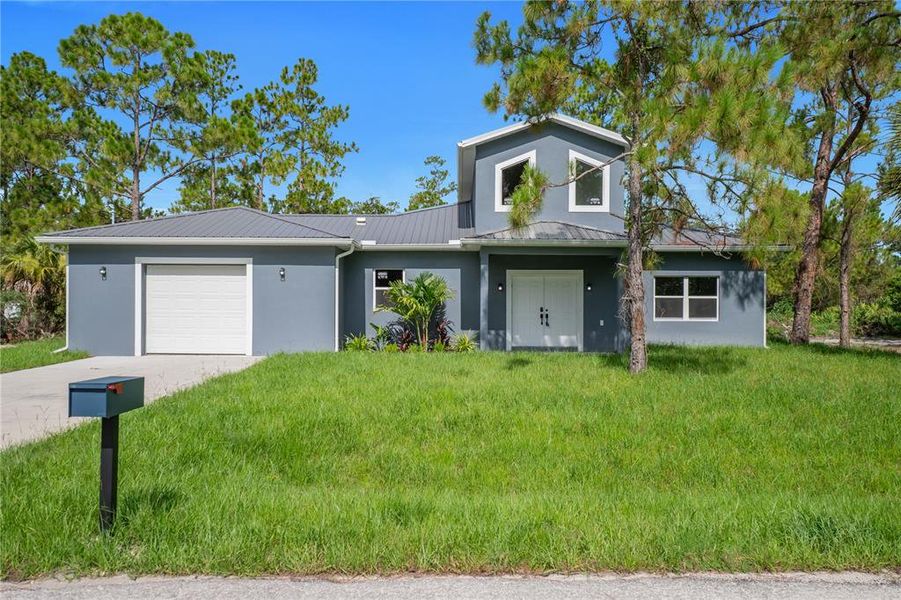 Front exterior of a new home in , Lehigh Acres, FL, highlighting curb appeal (Image 23).