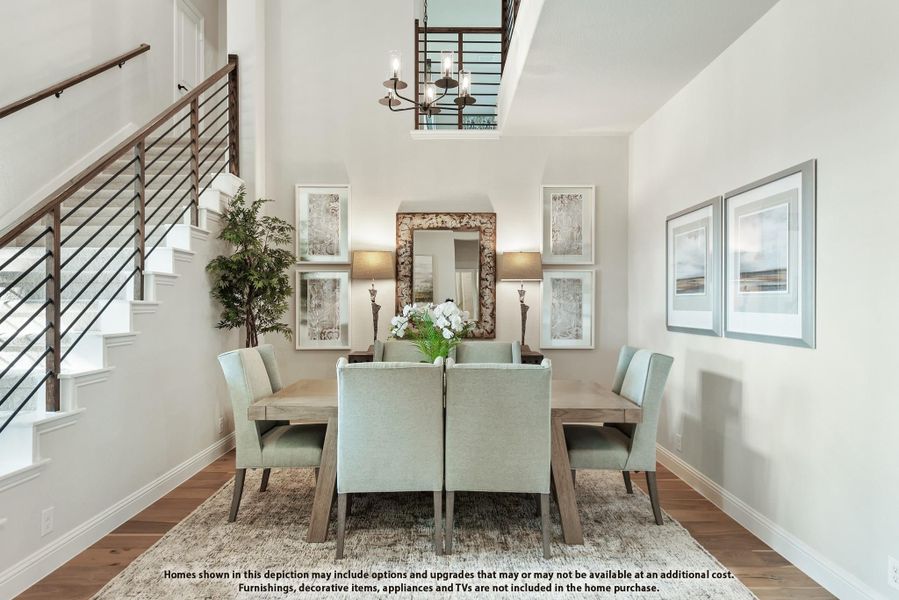Formal dining room with wood table, light blue chairs, chandelier, and staircase with wood railing nearby Formal dining room with wood table, light blue chairs, chandelier, and staircase with wood railing nearby