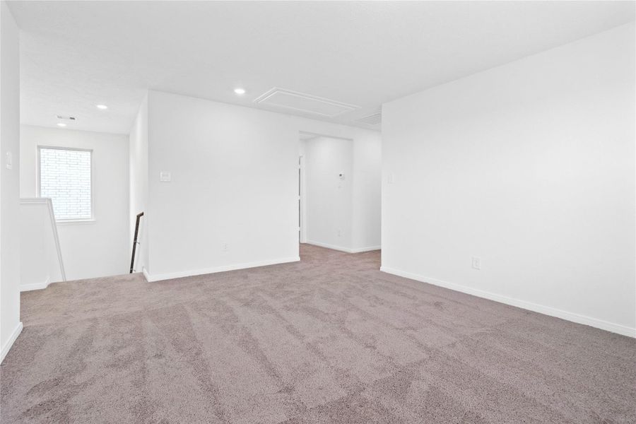 Additional view from the Loft, showcasing the staircase and hallway leading to the bedrooms and bathrooms.