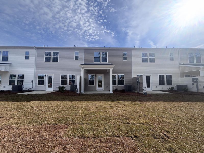 Exterior details and patio area of a home in Lindera Preserve at Cane Bay Plantation: Townhomes, Summerville (Image 3). Exterior details and patio area of a home in Lindera Preserve at Cane Bay Plantation: Townhomes, Summerville (Image 3).