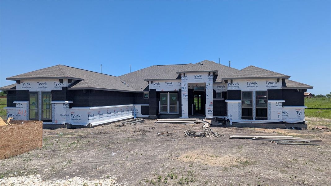 Front exterior of a new home in Scofield Farms Estates, Georgetown, TX, highlighting curb appeal (Image 21).