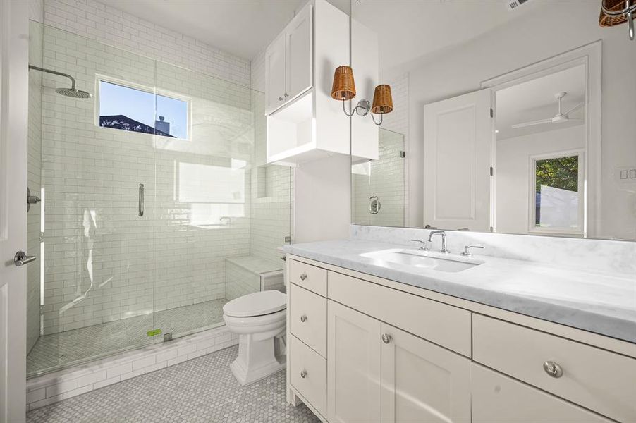 Bathroom with vanity, toilet, tile patterned floors, and an enclosed shower