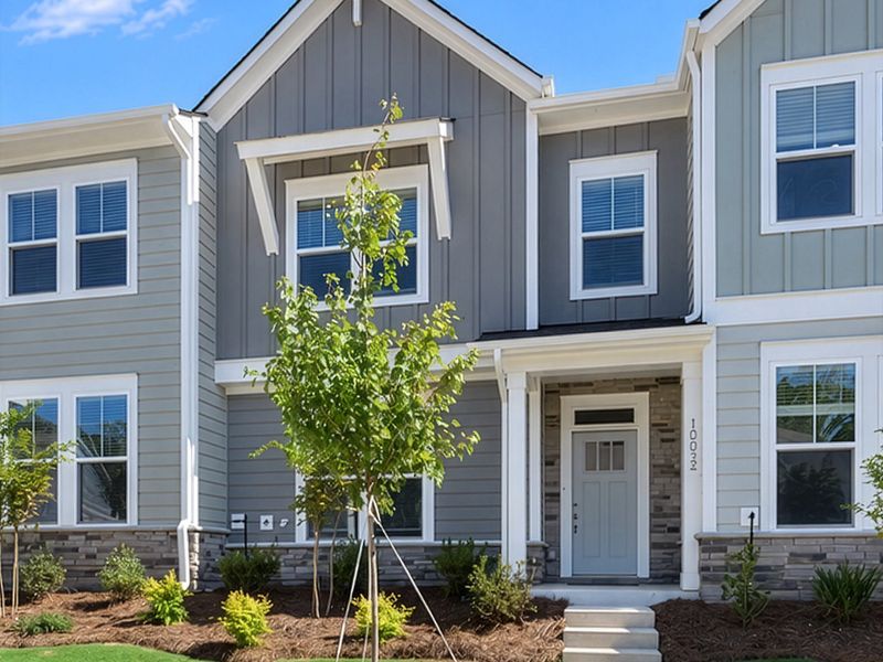 Front exterior of a new home in North Creek Village - Townhomes, Huntersville, NC, highlighting curb appeal (Image 1). Front exterior of a new home in North Creek Village - Townhomes, Huntersville, NC, highlighting curb appeal (Image 1).