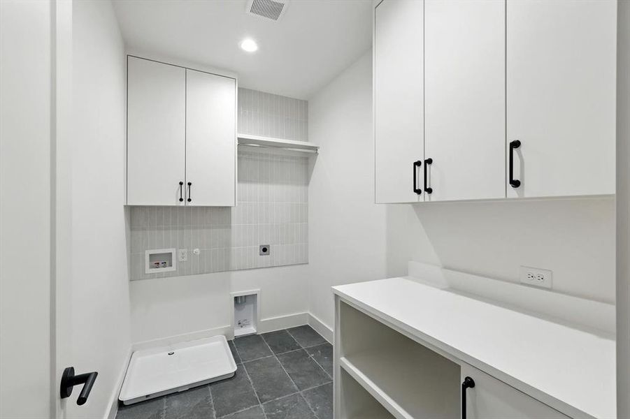 Laundry room featuring hookup for a washing machine, dark tile patterned floors, electric dryer hookup, and recessed lighting Laundry room featuring hookup for a washing machine, dark tile patterned floors, electric dryer hookup, and recessed lighting