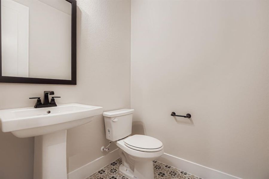 Half bathroom featuring baseboards and tile patterned floors
