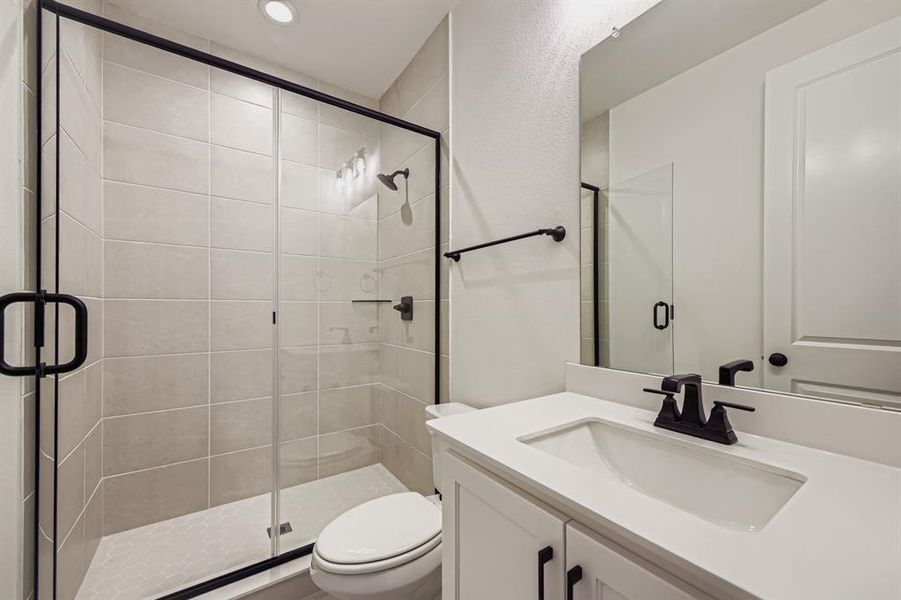 Bathroom with vanity, a stall shower, and recessed lighting