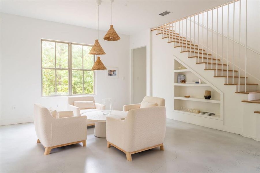 Living room with finished concrete floors, a wood ceiling with exposed beams, a ceiling fan, a fireplace, and recessed lighting Living room with finished concrete floors, a wood ceiling with exposed beams, a ceiling fan, a fireplace, and recessed lighting