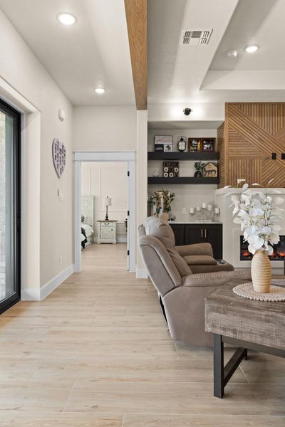 Living area with light wood-type flooring, recessed lighting, and baseboards Living area with light wood-type flooring, recessed lighting, and baseboards