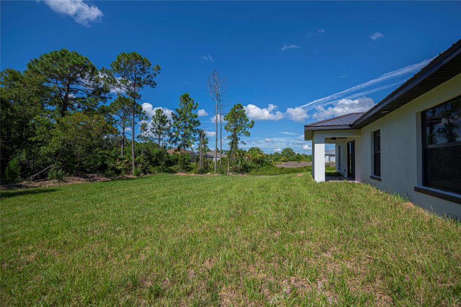 Front exterior of a new home in , Lehigh Acres, FL, highlighting curb appeal (Image 13).