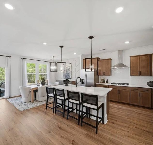 An open-concept design with natural wood flooring An open-concept design with natural wood flooring