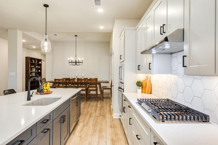 This astonishing two-toned kitchen is refreshing and is such an exciting design element. The open-concept design is perfect for modern living.