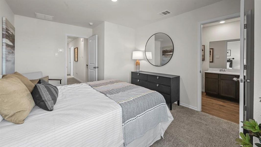 Carpeted bedroom featuring ensuite bathroom and recessed lighting
