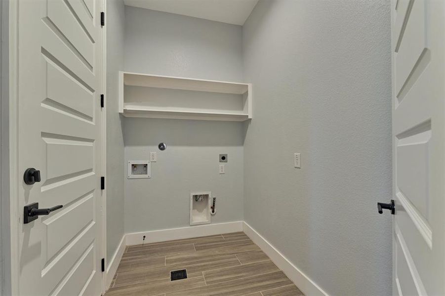 Utility room off of the of the foyer has access to the garage.