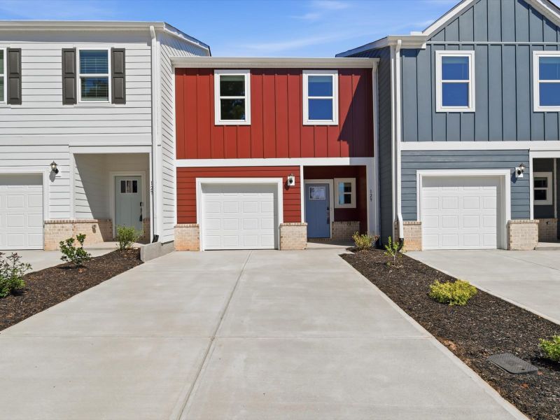 Front exterior of a new home in Crossing at Abner Creek Townes, Greer, SC, highlighting curb appeal (Image 1). Front exterior of a new home in Crossing at Abner Creek Townes, Greer, SC, highlighting curb appeal (Image 1).