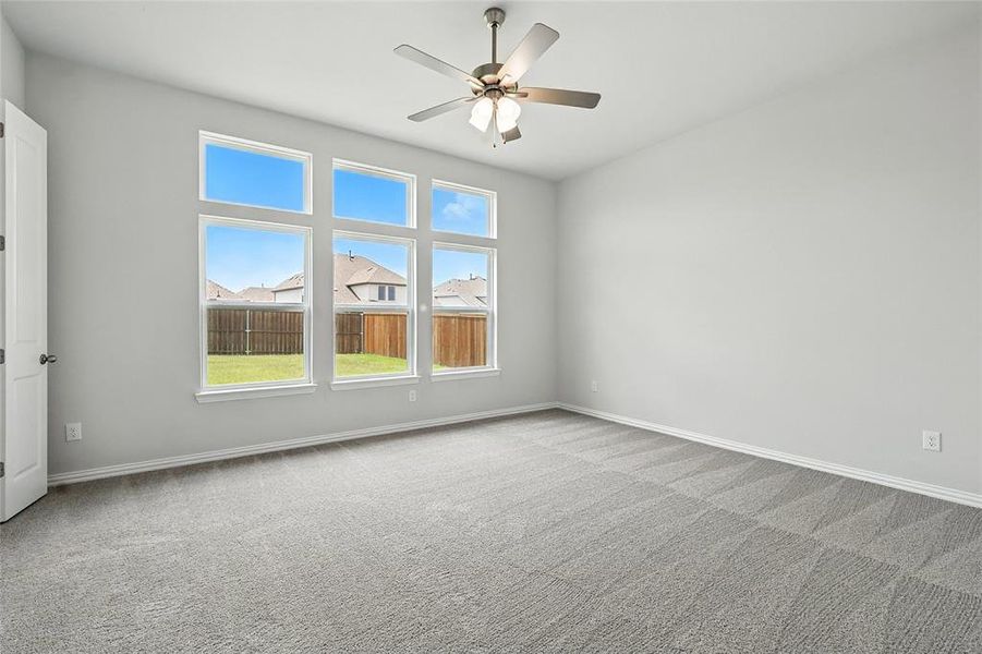 Unfurnished room with light carpet and ceiling fan