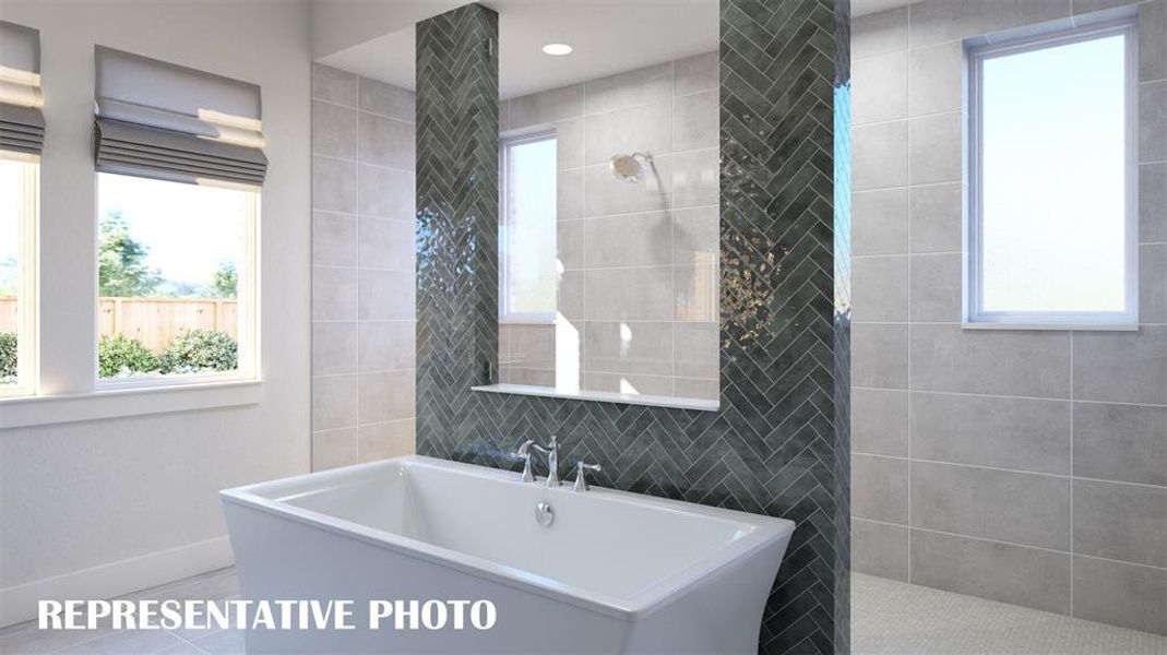 Featuring a walk through double shower, drying space and a free standing tub, this owner's bath is one for the ages!  REPRESENTATIVE PHOTO
