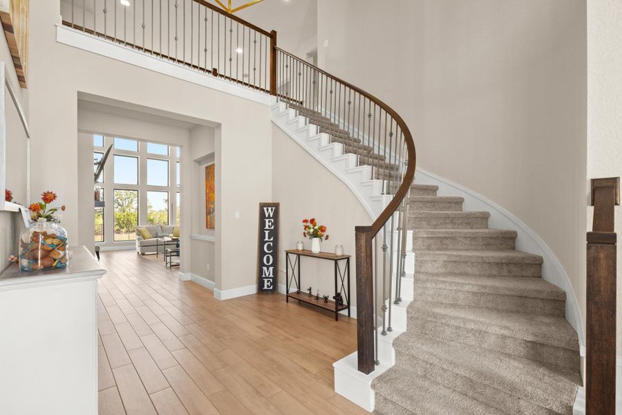 Stairs with a high ceiling and wood finished floors Stairs with a high ceiling and wood finished floors