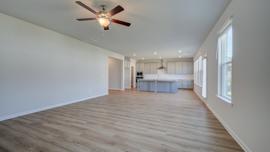 Expansive family room with LVP flooring, natural light, and views to breakfast area and kitchen in Ridgewood at Bowers Farm.