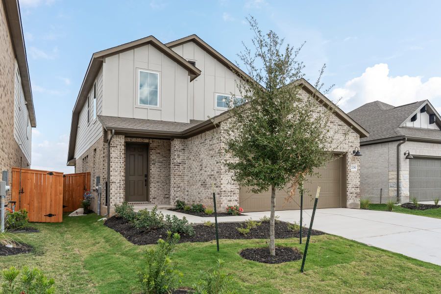 Front exterior of a new home in Lariat, Liberty Hill, TX, highlighting curb appeal (Image 22).